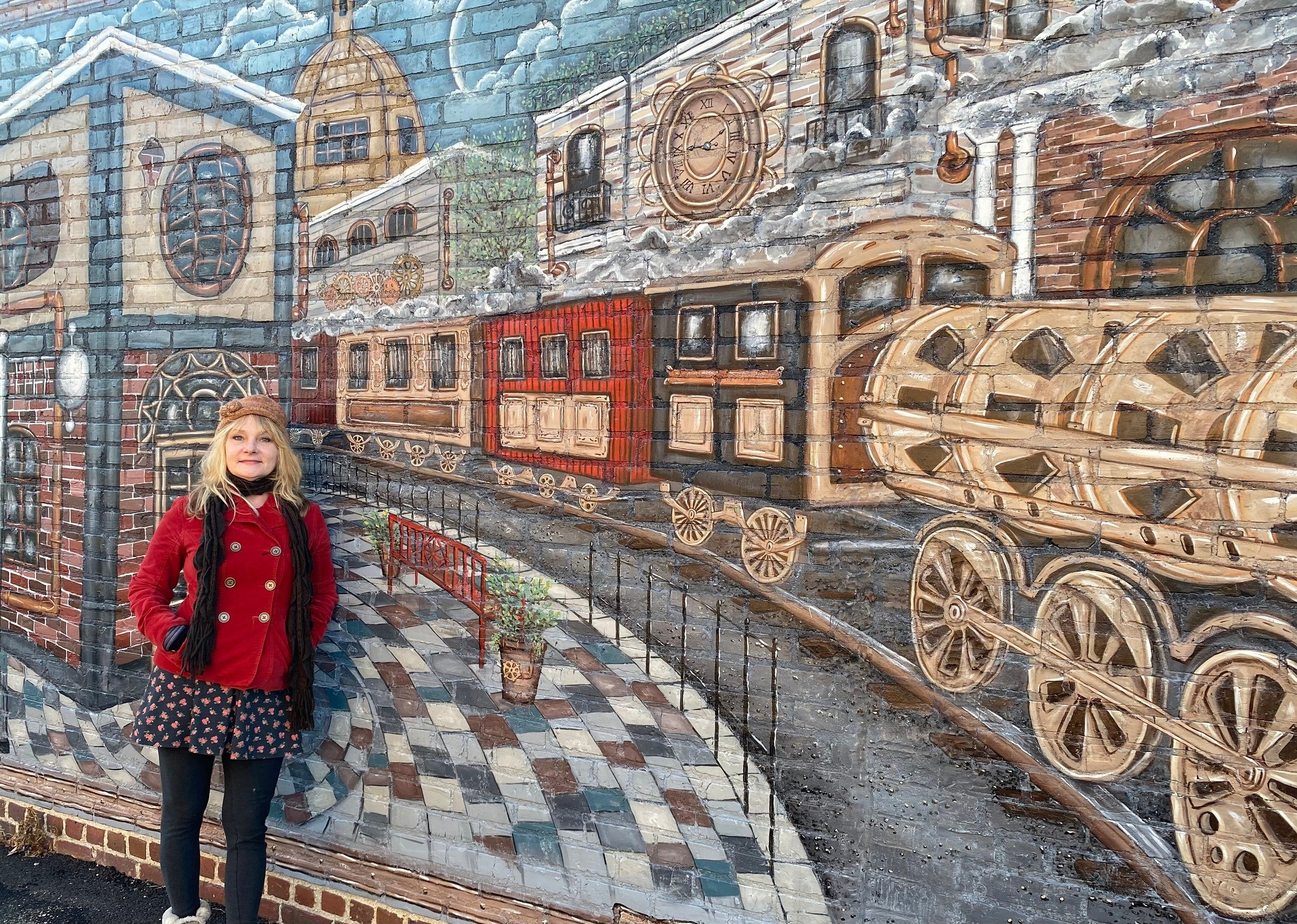 Katie Grottenthaler standing in front of train mural in Ashland, Virginia